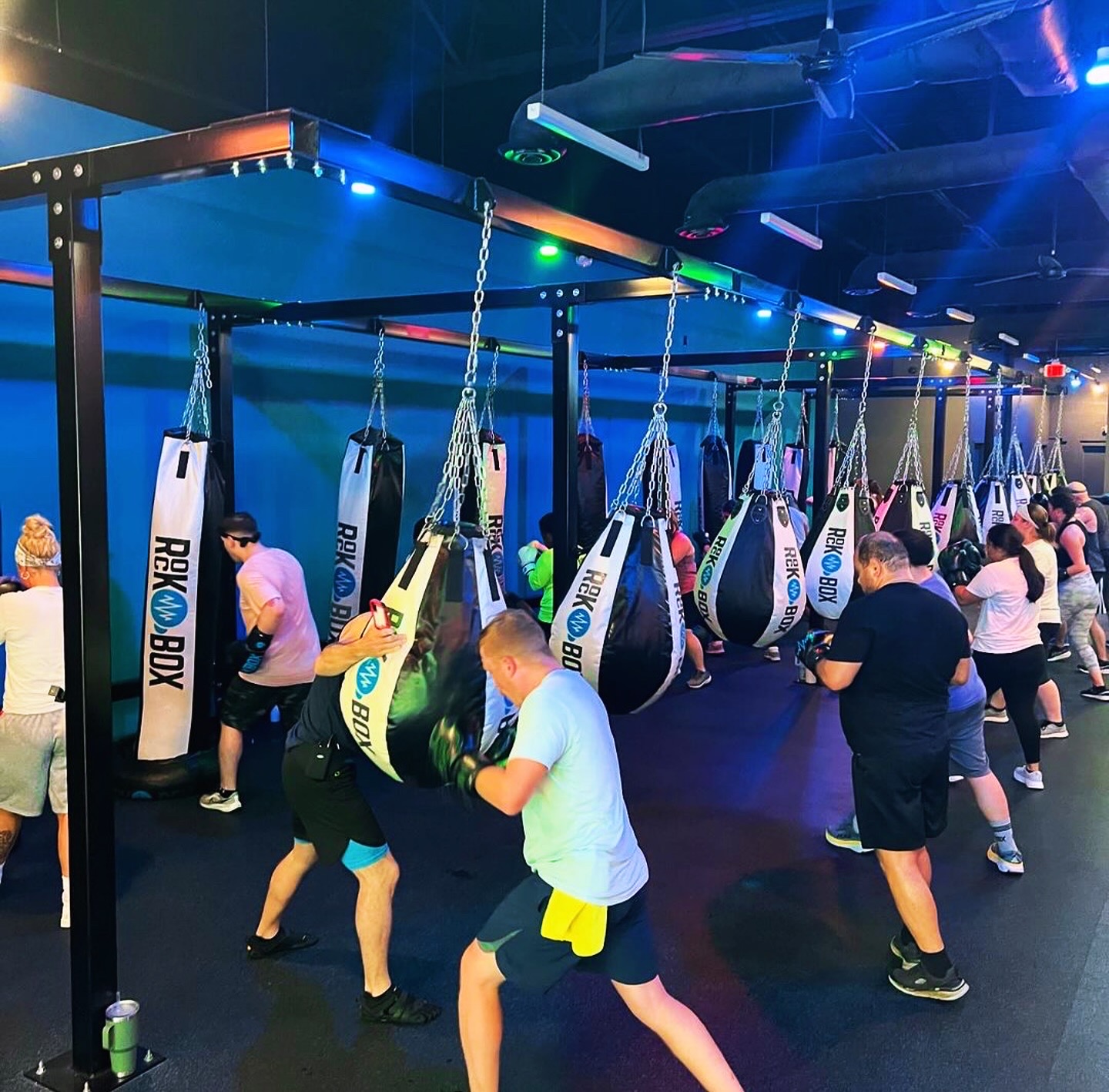 RockBox Fitness Summerville members training on heavy bags during a group class